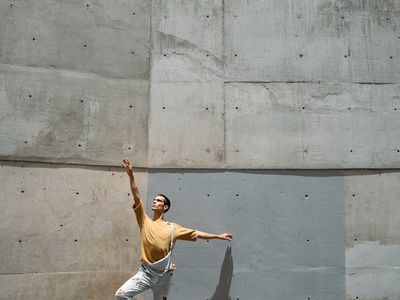 Shadow of a man performing dynamic lunges against wall